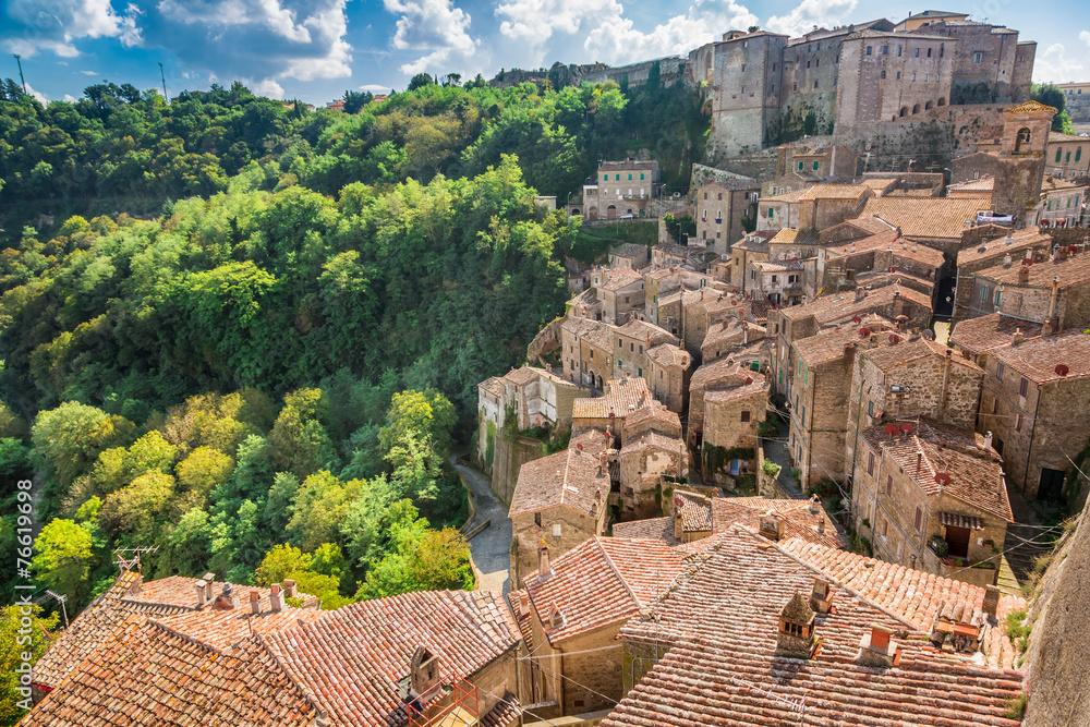 View of a green valley in Sorano over red roofs, Italy - obrazy, fototapety, plakaty 