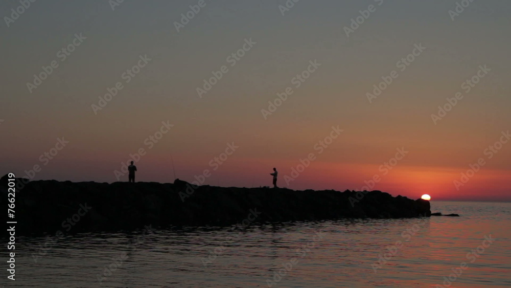 fishermen fishing on the rocks at sunset -fischerman - sea fishermen fishing on the rocks at sunset -fischerman - sea