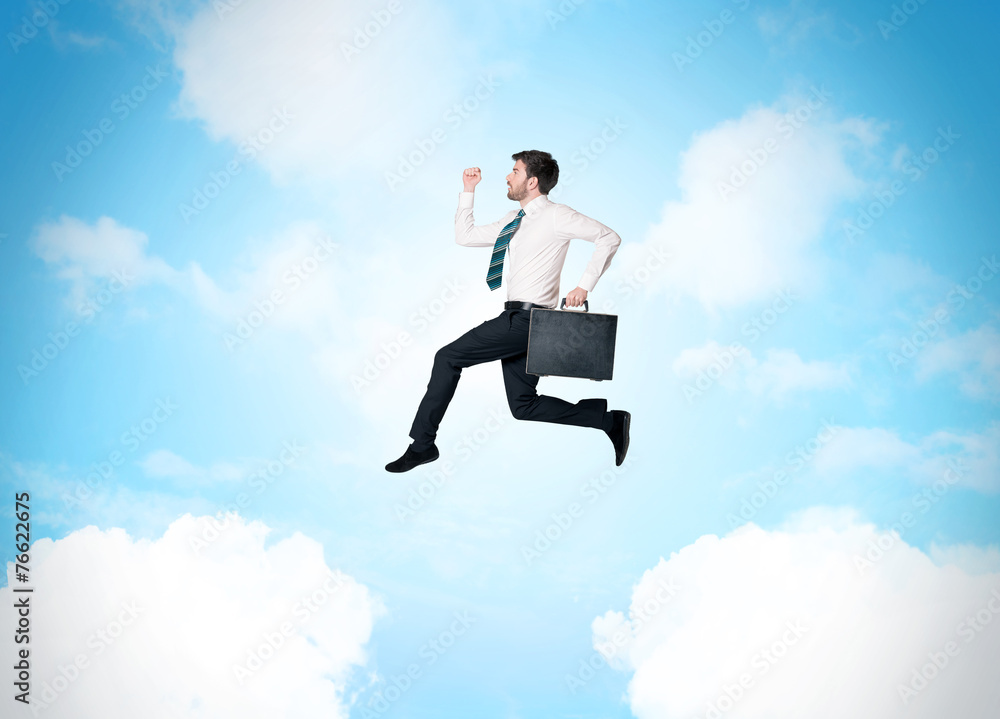 Business person jumping over clouds in the sky Business person jumping over clouds in the sky
