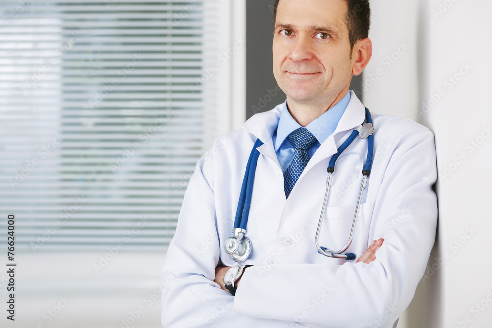 Portrait of confident doctor with crossed hands looking at the c Portrait of confident doctor with crossed hands looking at the c