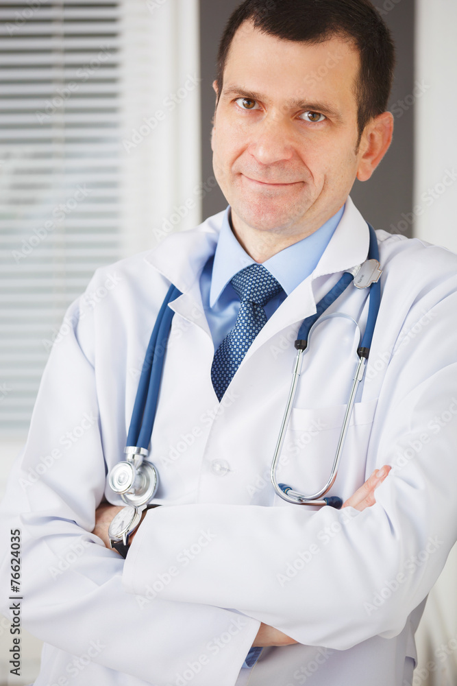 Portrait of confident doctor with crossed hands looking at the c Portrait of confident doctor with crossed hands looking at the c