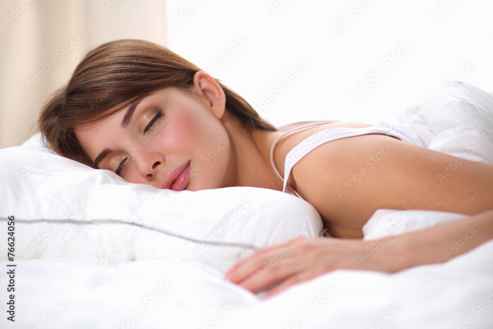 Beautiful girl sleeps in the bedroom, lying on bed Beautiful girl sleeps in the bedroom, lying on bed
