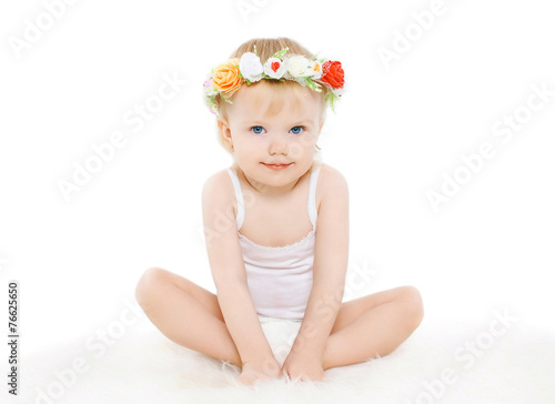 Little girl with floral wreath on his head on a white background