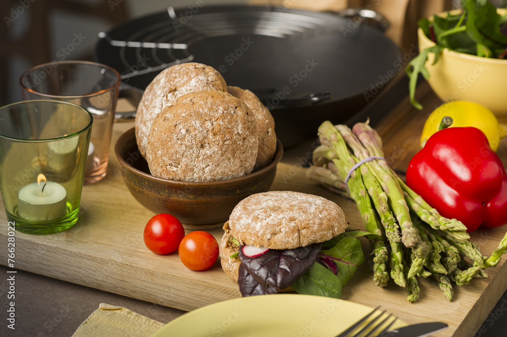 Fresh vegetables and rolls in a kitchen Fresh vegetables and rolls in a kitchen