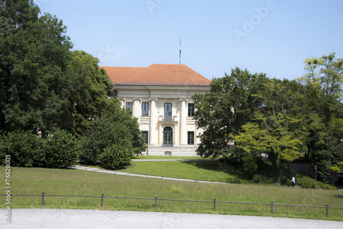 secluded traditional white mansion with red rood in sunny day