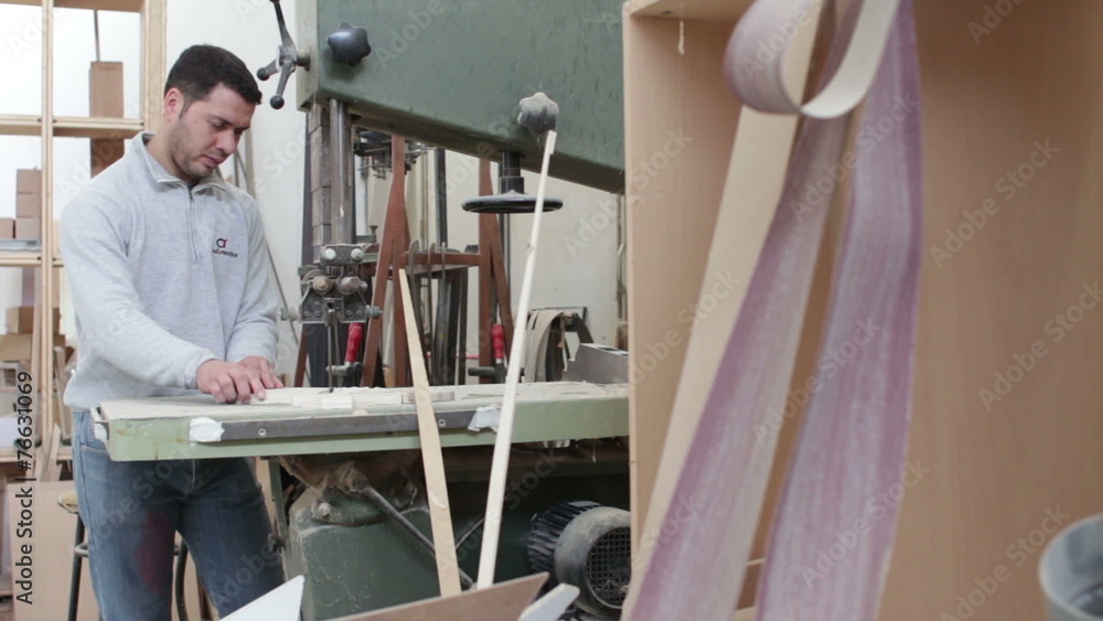 woodworker sawing wood with a band saw - carpenter in carpentery - dolly woodworker sawing wood with a band saw - carpenter in carpentery - dolly