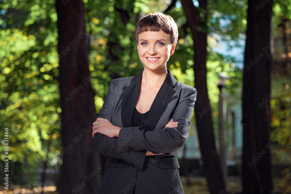 Confident smiling businesswoman keeping arms crossed outdoors Confident smiling businesswoman keeping arms crossed outdoors
