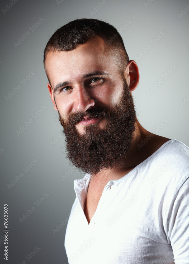 Portrait of handsome bearded man standing, isolated on grey Portrait of handsome bearded man standing, isolated on grey