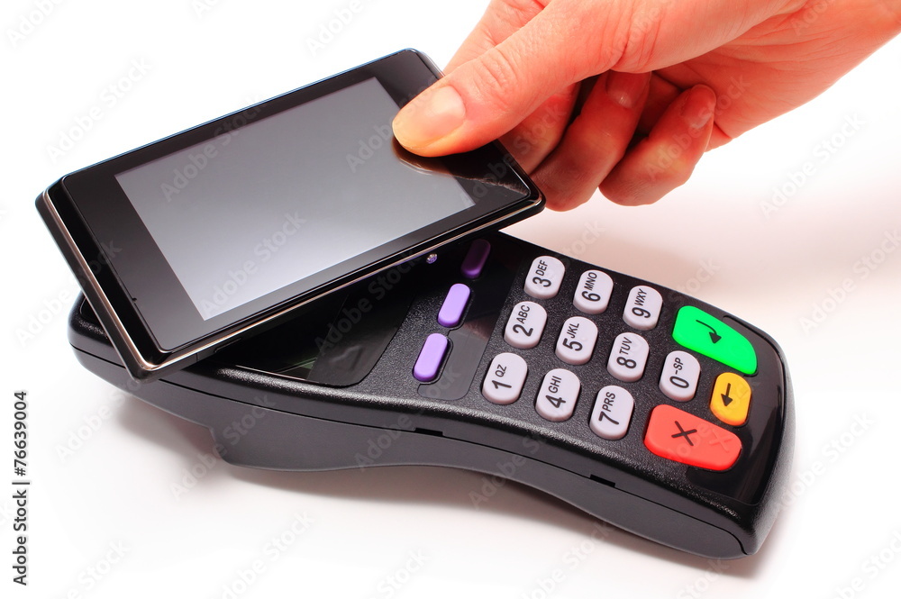 Hand of woman paying with NFC technology on mobile phone Hand of woman paying with NFC technology on mobile phone