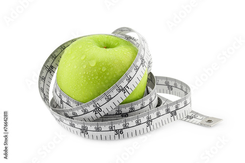 Green Apple with measuring tape on white background