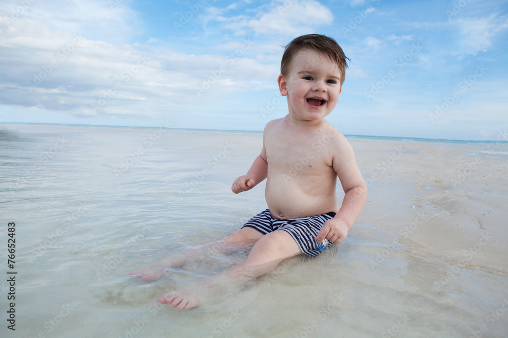 Boy enyojs summer day at the tropical beach. Boy enyojs summer day at the tropical beach.