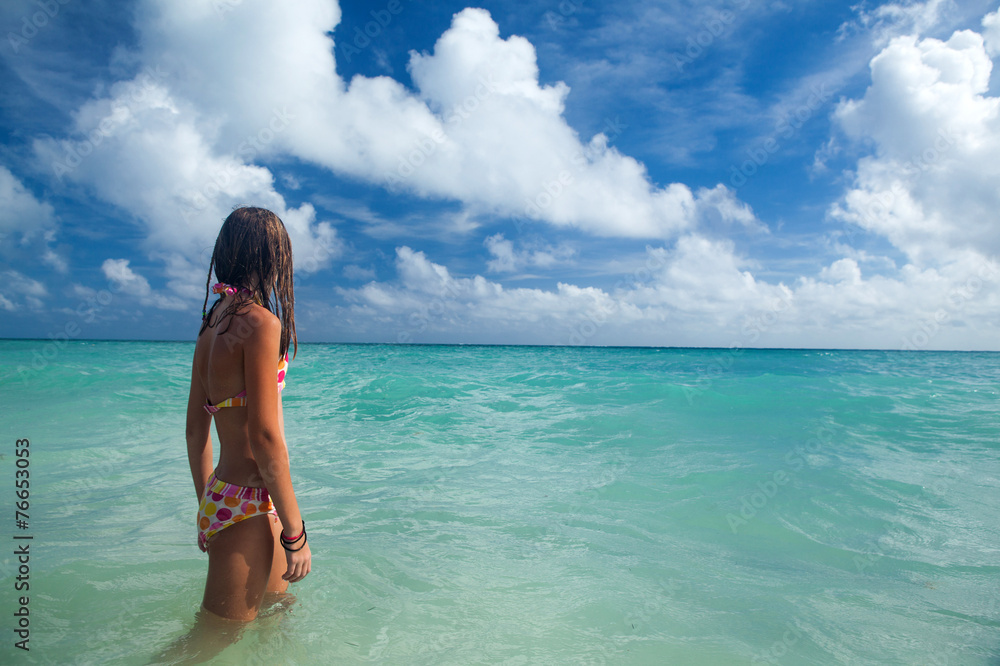 Girl enjoys summer day at the tropical beach. Girl enjoys summer day at the tropical beach.