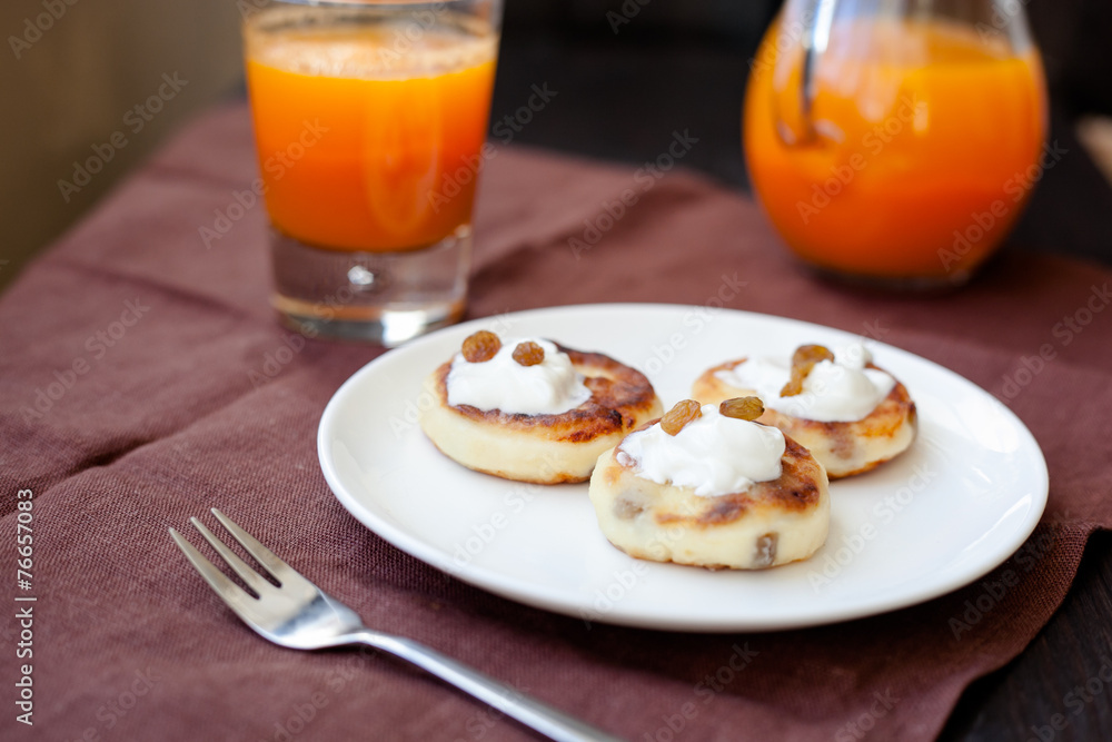 Delicious homemade cheese pancakes with fresh carrot juice Delicious homemade cheese pancakes with fresh carrot juice