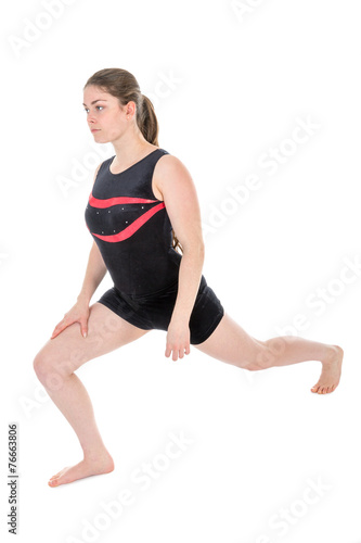 Young woman warming up for a gymnastics exercise.