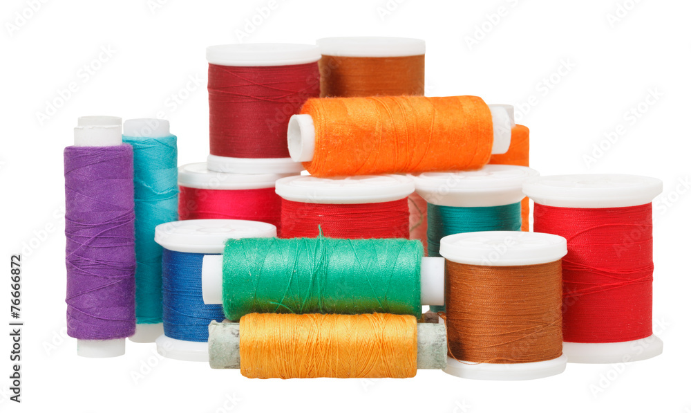 multicolored thread spools isolated on white multicolored thread spools isolated on white
