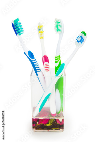 colorful family toothbrushes isolated on white background