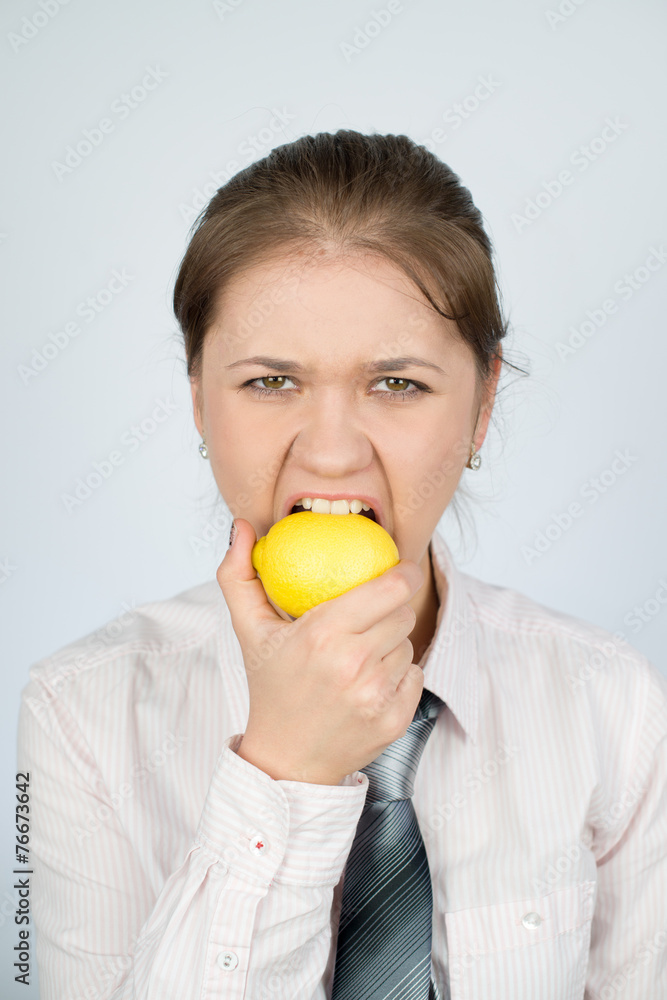 business woman eating a lemon business woman eating a lemon