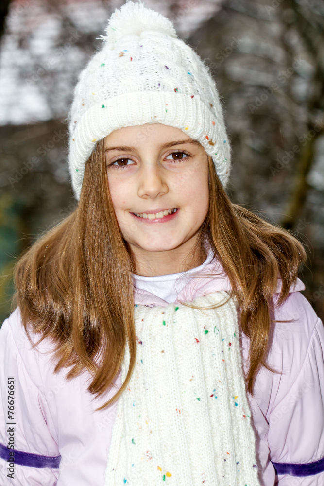 Happy little girl posing in winter hat - outdoor photo Happy little girl posing in winter hat - outdoor photo