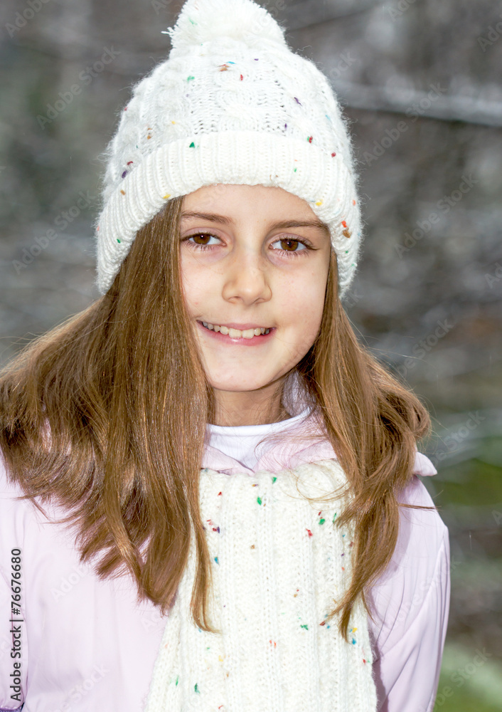 Happy little girl posing in winter hat - outdoor photo Happy little girl posing in winter hat - outdoor photo