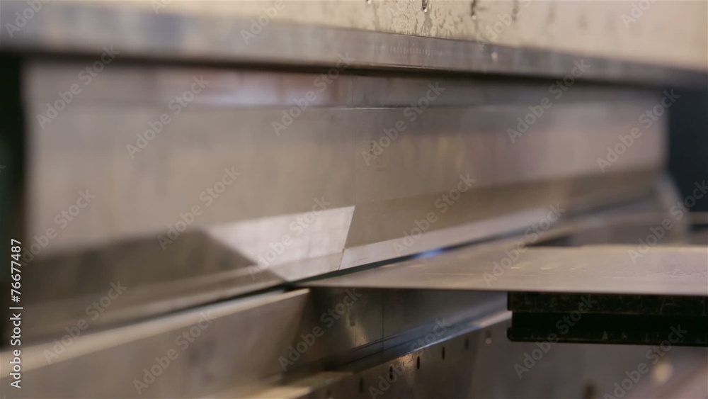 Machine flexes metal sheet Machine flexes metal sheet