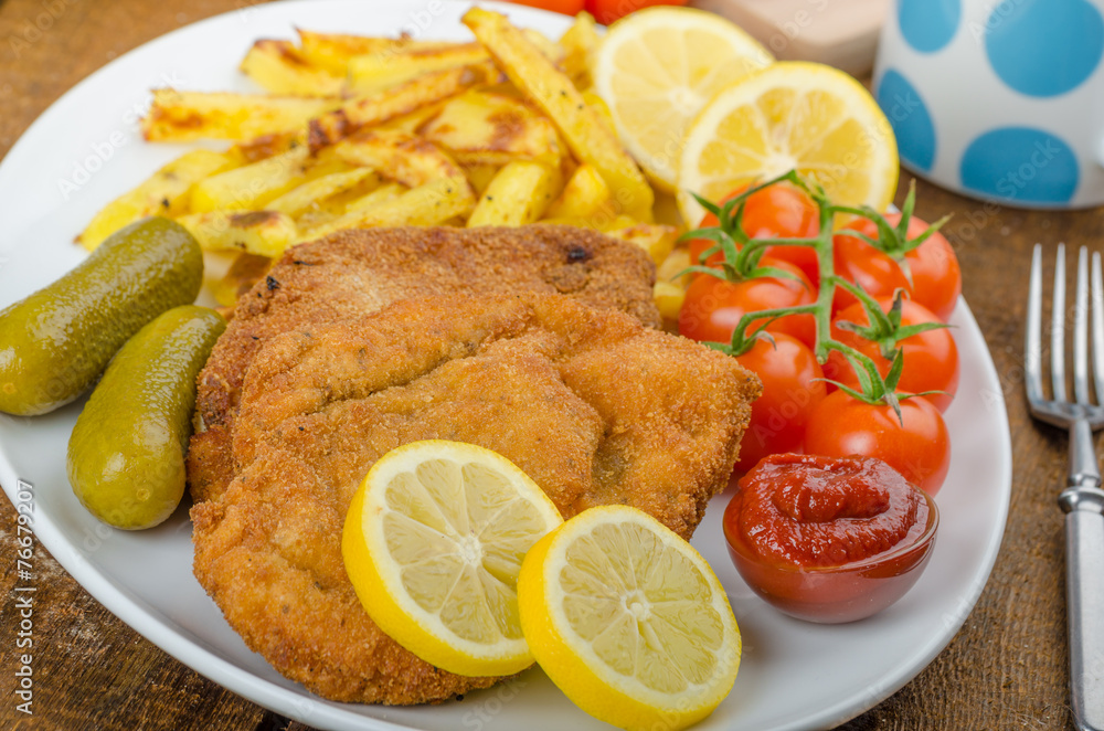 Big Chicken schnitzel with homemade chilli french fries Big Chicken schnitzel with homemade chilli french fries