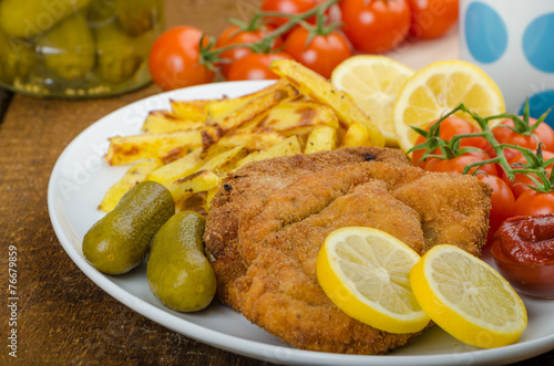 Big Chicken schnitzel with homemade chilli french fries photo