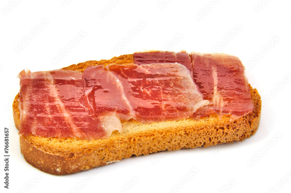 Spanish serrano ham on bread slice. White background. Tapa. Spanish serrano ham on bread slice. White background. Tapa.