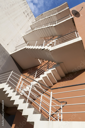 stairs outside bulding, emergency exit, fire escape, orange wall