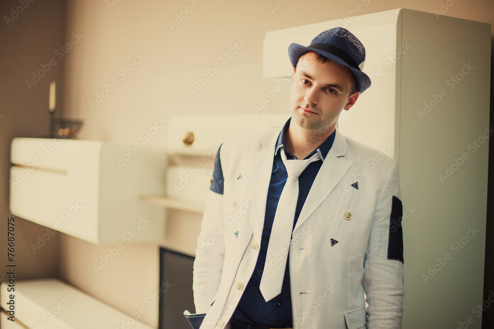 groom standing in the room groom standing in the room