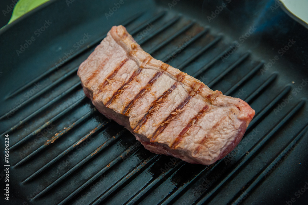 Rare beef rump steak on a griddle pan