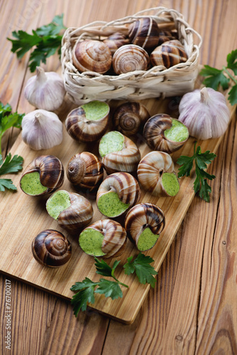 Bourguignonne snail au gratin, rustic wooden background