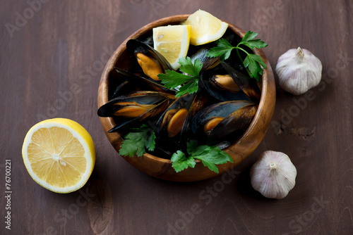 Steamed mussels with parsley, lemon and garlic, high angle view