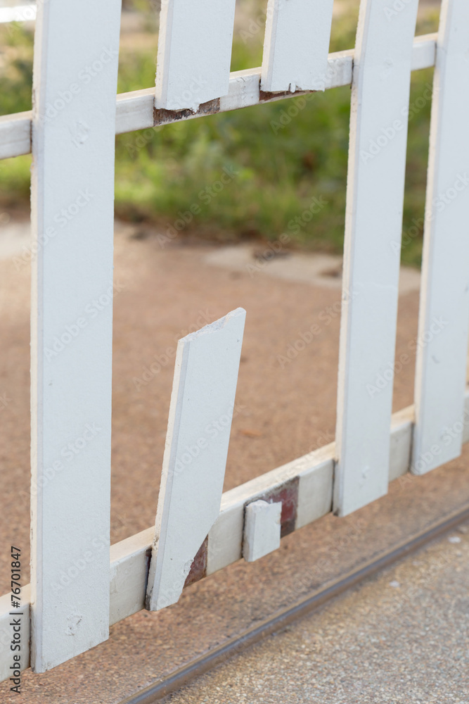 white wood fence of broken damaged