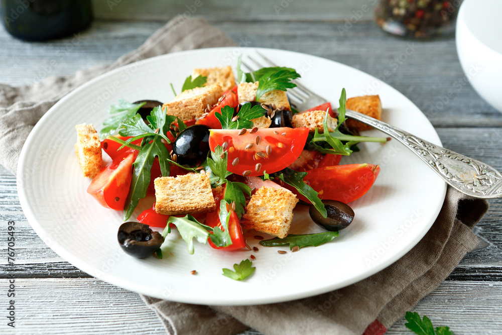 Fresh salad with tomatoes and croutons on a plate Fresh salad with tomatoes and croutons on a plate