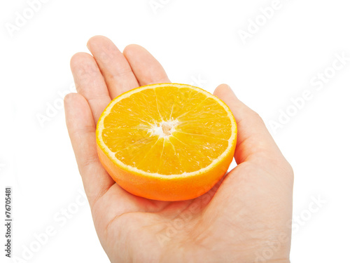 Hand holding half an orange on a white background.