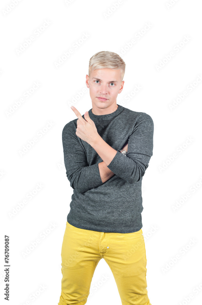 Young handsome guy showing somewhere with finger Young handsome guy showing somewhere with finger