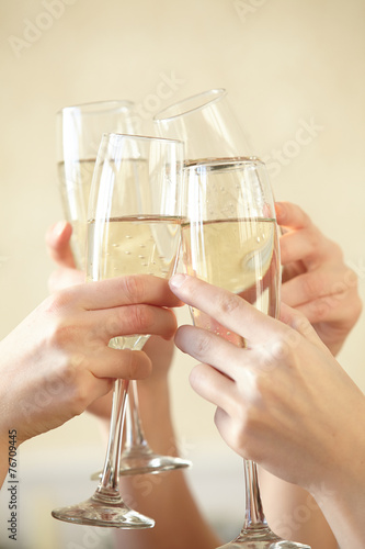 Glasses of champagne in female hands on a party