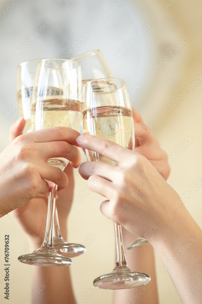 Glasses of champagne in female hands on a party