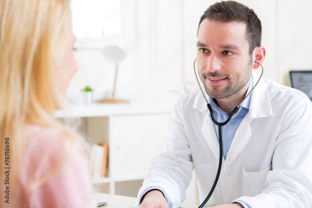 Fototapeta premium Young attractive doctor listening his patient