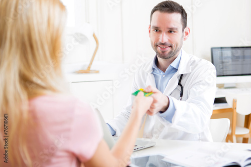 Young attractive doctor taking health insurance card