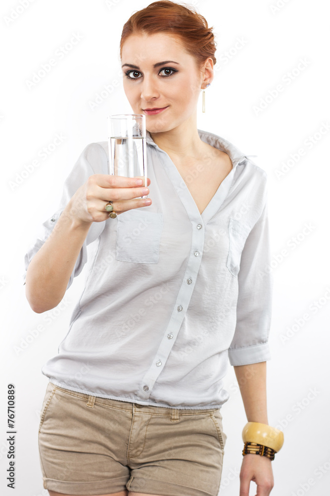 Happy young girl with a glass of water.