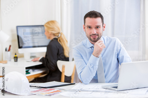 Young attractive engineer working at the office