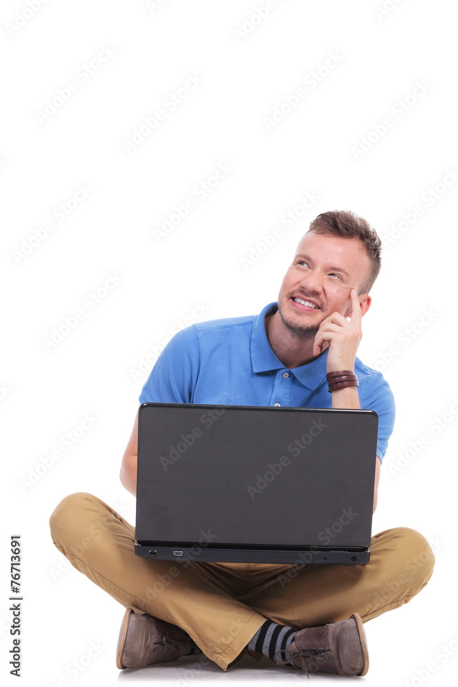 pensive seated young man with laptop pensive seated young man with laptop