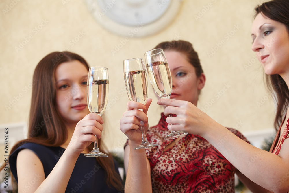 beautiful girls at a Christmas party with glasses of champagne beautiful girls at a Christmas party with glasses of champagne