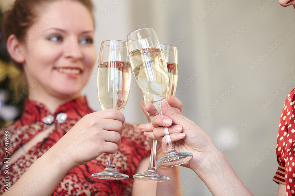 beautiful girls at a Christmas party with glasses of champagne beautiful girls at a Christmas party with glasses of champagne