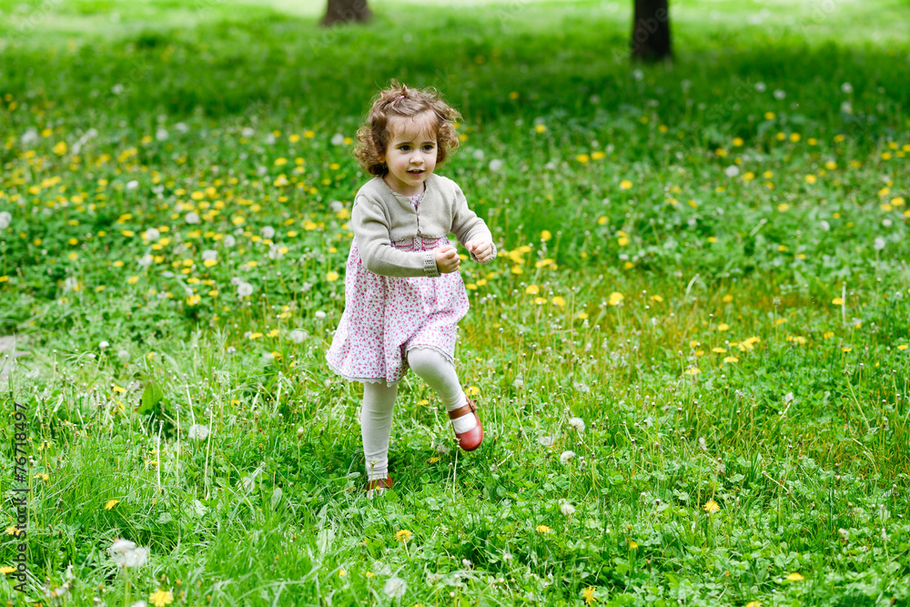 Little girl running and playing in the park Little girl running and playing in the park