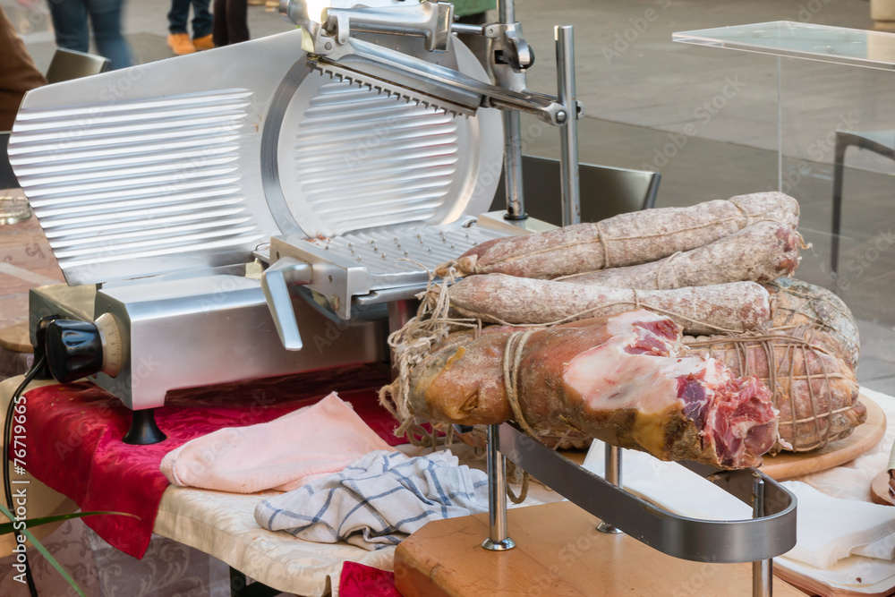 Parma ham, salami and ham slicer on the sidewalk in street Stock Photo |  Adobe Stock