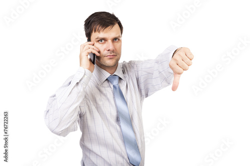 Portrait of disappointed young business man showing thumb down s