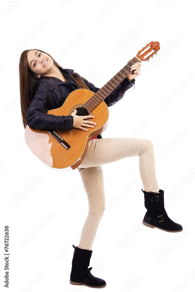 Full length portrait of happy teenage girl playing guitar
