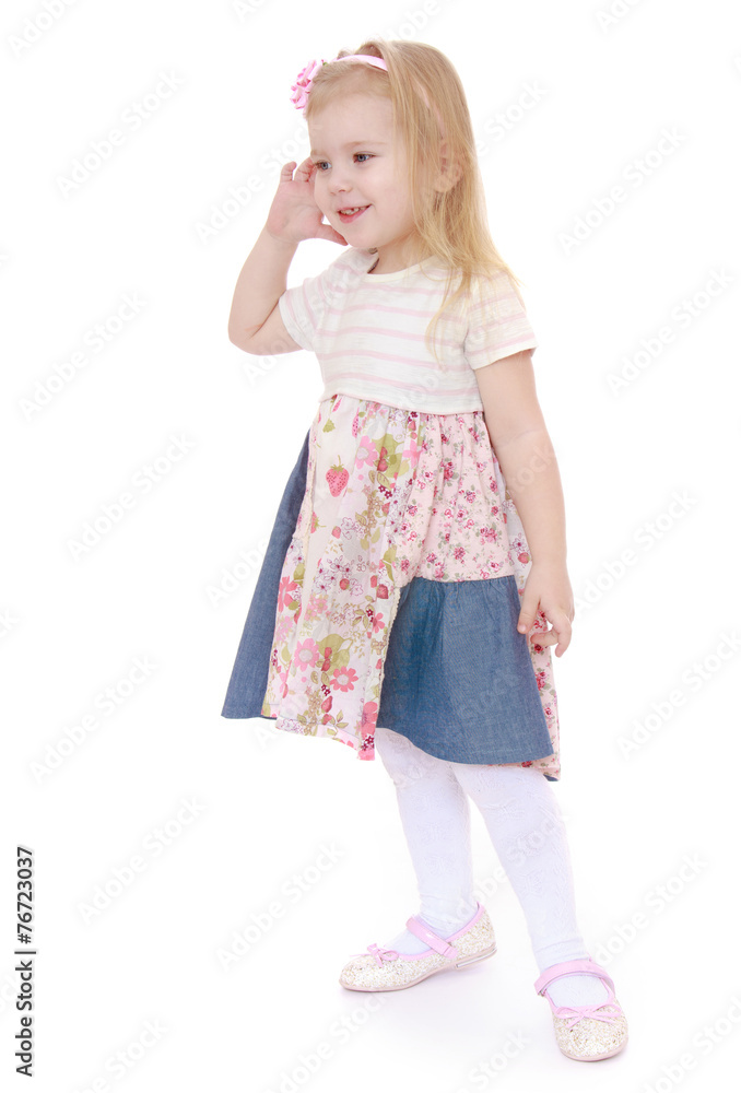 Adorable little girl holding a hand in front of face. Adorable little girl holding a hand in front of face.